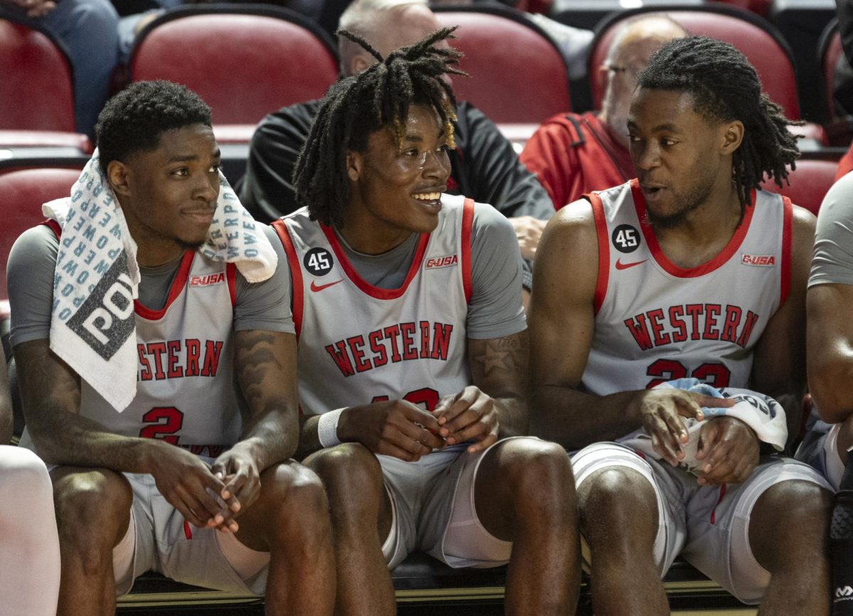 Team members congratulate Julius Thedford (middle, 13) after he scored a dunk against Jackson State University at E.A. Diddle Arena on Nov. 20, 2024.