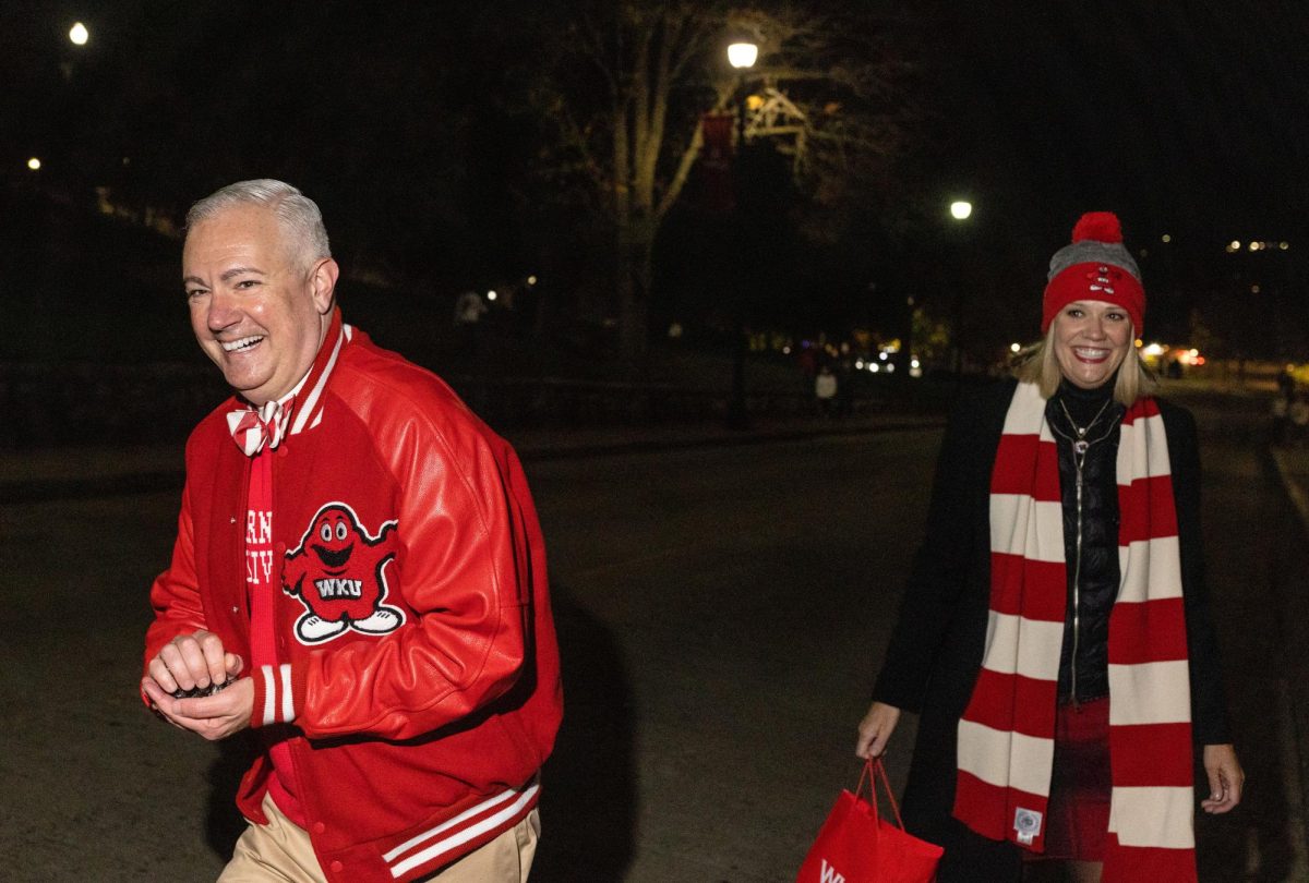 WKU President Timothy C. Caboni and his wife Kacy Caboni make their way to different sororities and fraternities before the WKU Homecoming Parade in Bowling Green on Friday, Nov. 15, 2024. 