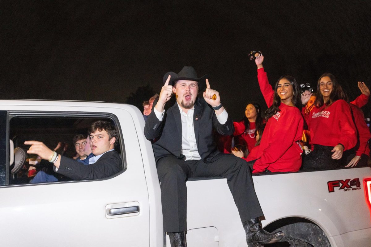 Senior Kappa Alpha member Bernie Sams cheers as his float starts on the parade route on College St. during the WKU Homecoming Parade in Bowling Green on Friday, Nov. 15, 2024. 