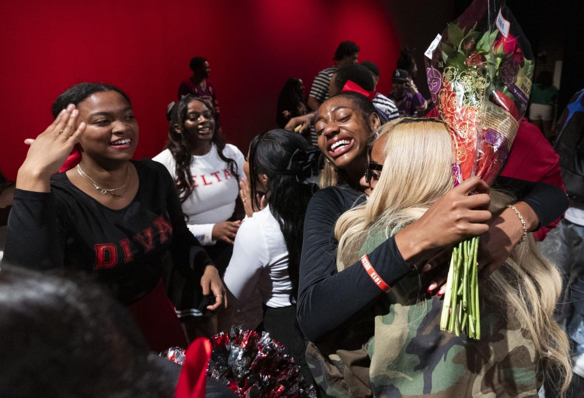 Hannah Turner, member of Delta Sigma Theta Sorority, Inc., hugs her sister Morgan Wynne while she celebrates winning first place in the 2024 Homecoming Step Show Performance on Saturday Nov. 16, 2024. “I am so unbelievably proud of my sisters and all we’re able to accomplish. There’s no greater feeling than accomplishing a huge goal with the people you love,” Turner said. 