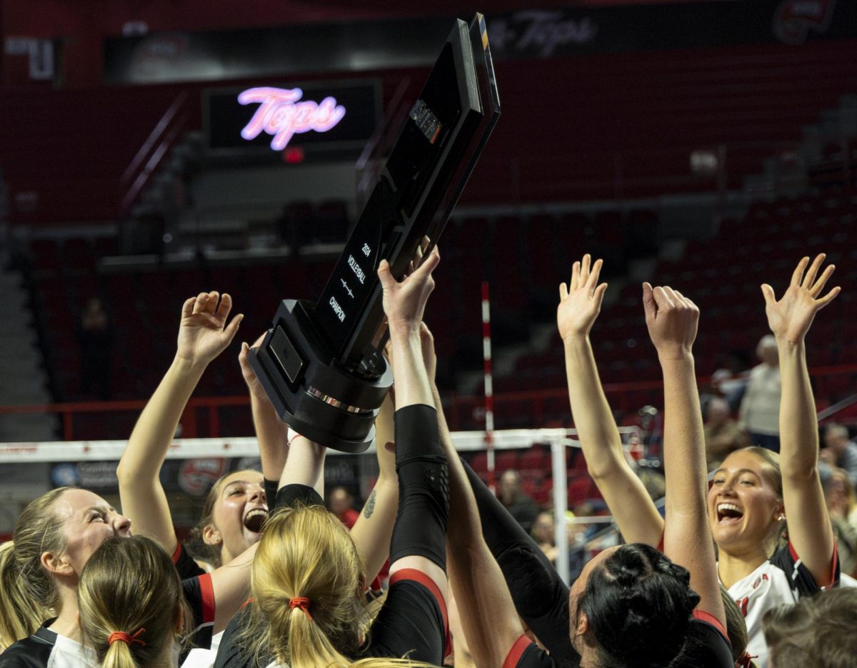 The Western Kentucky Hilltoppers women’s volleyball team celebrates after being awarded the conference champions trophy following their win against Liberty University at Diddle Arena on Nov. 14, 2024. WKU won 3-0, and is 17-0 in conference play. 