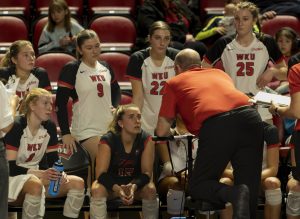 The women of Western Kentucky’s volleyball team listen to head coach Travis Hudson during a time out during the matchup against Liberty University at Diddle Arena on Nov. 14, 2024. 