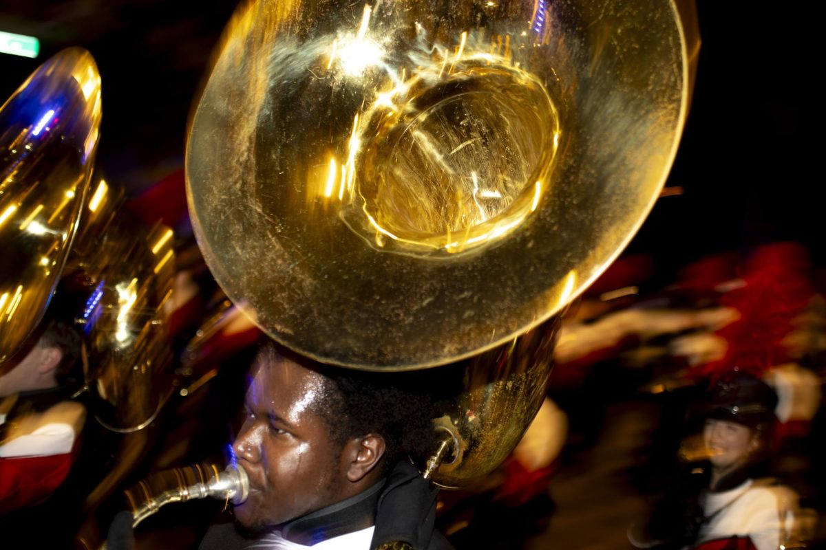 A member of the Big Red Marching Band carries his sousaphone down College St. while leading the start of WKU’s Roaring Red Homecoming Parade on Friday, Nov. 15, 2024. 