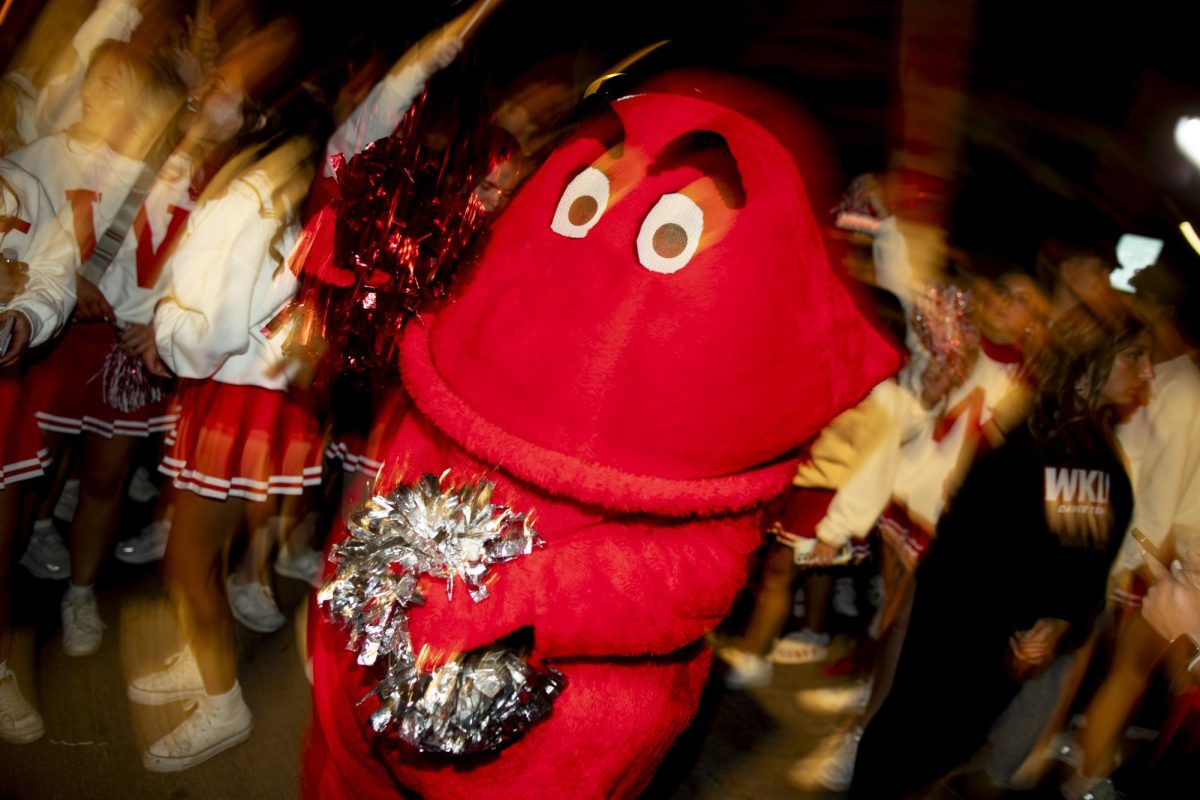 WKU’s Big Red borrows some pompoms from the dance team to hype up the crowd at the annual Big Red Roar after WKU’s “Roaring Red” Homecoming Parade on Friday, Nov. 15, 2024. 