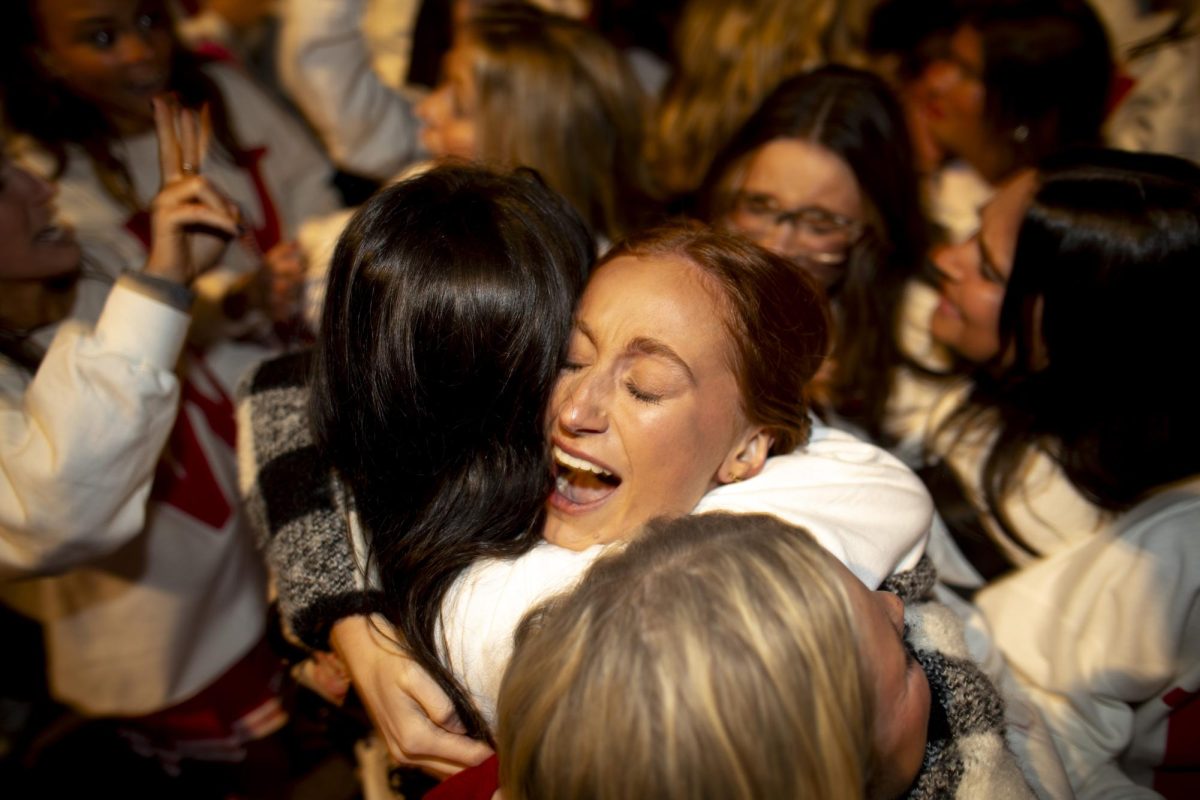 Homecoming queen candidate and sorority float chair, Caitlyn Blandford, embraces her sorority sister after Alpha Delta Pi won first overall in parade festivities after WKU’s “Roaring Red” Homecoming Parade on Friday, Nov. 15, 2024. 