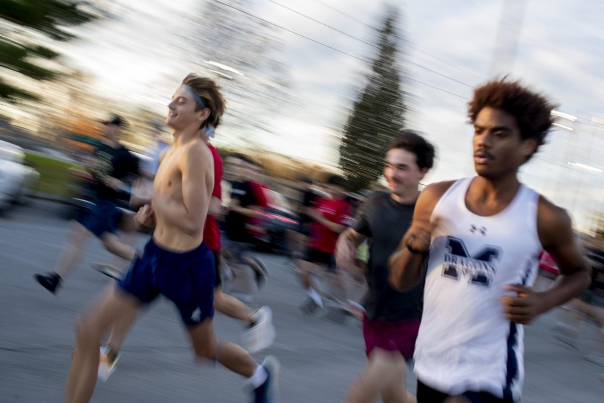 Warren Central High School junior Ty Taylor, 16, (right) pushes to the front at the start of SGA’s Veteran's Day 5K at Kereiakes Park in Bowling Green on Friday, Nov. 8, 2024. 