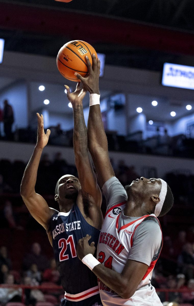 Western forward Tyrone Marshall Jr. (24) rejects a layup attempt from Jackson State guard Marcus Watson Jr. (21) during WKU’s game against the Jackson State Tigers on Wednesday, Nov. 20, 2024 in E.A. Diddle Arena. Marshall contributed 6 points to WKU’s 40-28 first half lead. 