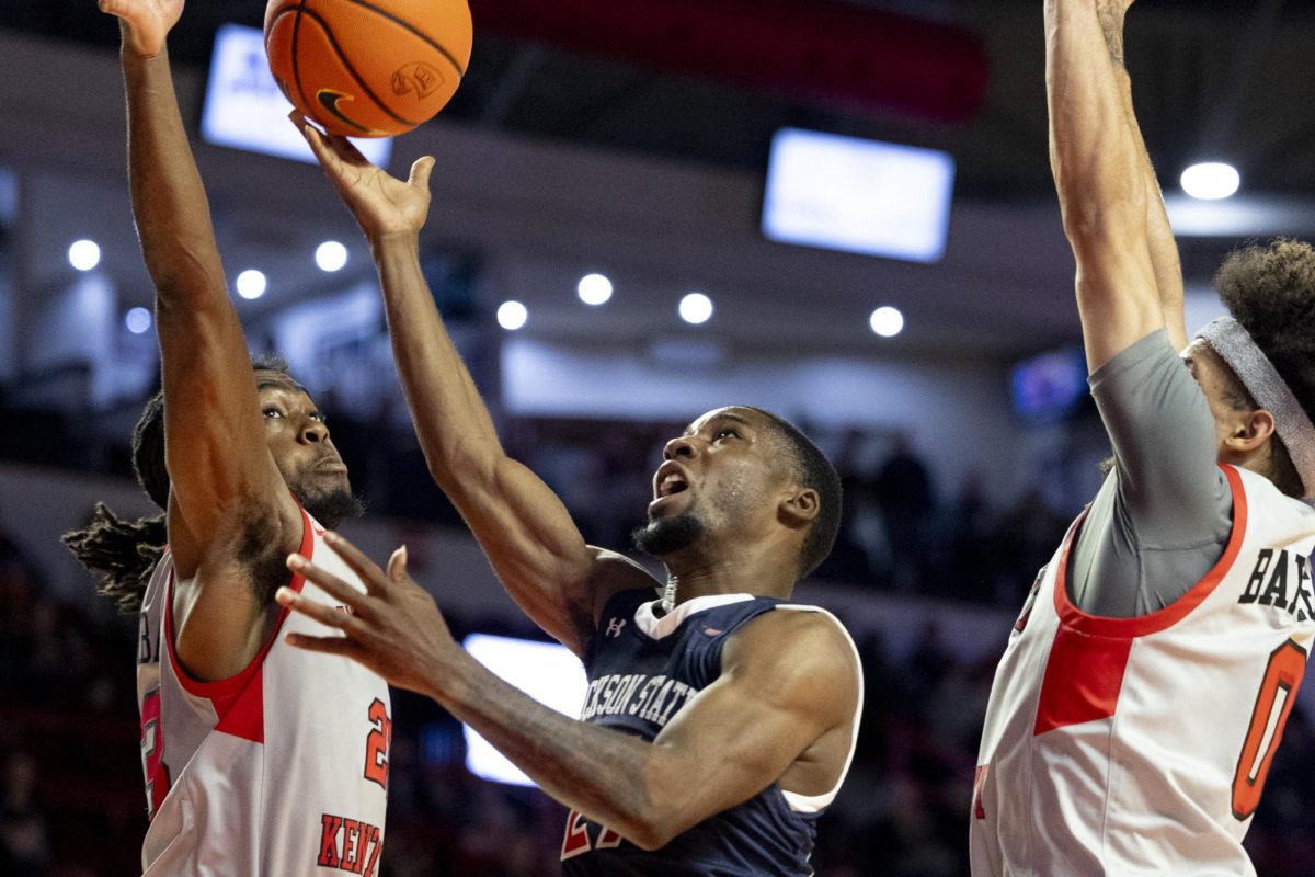 WKU guards Enoch Kalambay (23) and Braxton Bayless (0) jump to block a layup attempt at the basket by Jackson State’s Marcus Watson Jr. (21) during WKU’s game against the Jackson State Tigers on Wednesday, Nov. 20, 2024 in E.A. Diddle Arena. 