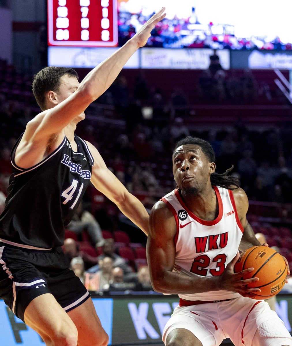 Senior guard Enoch Kalambay (23) eyes the basket with opposition from Lipscomb’s forward Jacob Ognacevic (41) during WKU’s win against Lipscomb on Sunday, Nov. 17, 2024 in E.A. Diddle Arena. 