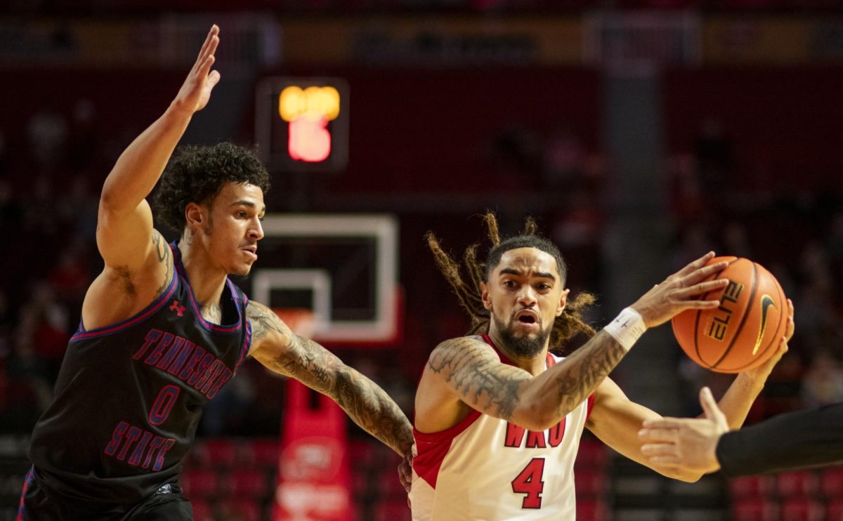 WKU guard Khristian Lander (4) drives the ball during the Hilltopper's game against Tennessee State University in Bowling Green, Ky. on Tuesday, Dec. 10, 2024.