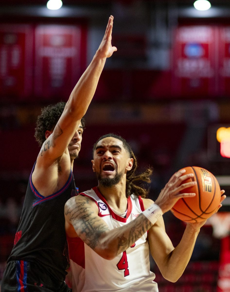 WKU guard Khristian Lander (4) drives the ball during the Hilltopper's game against Tennessee State University in Bowling Green, Ky. on Tuesday, Dec. 10, 2024.