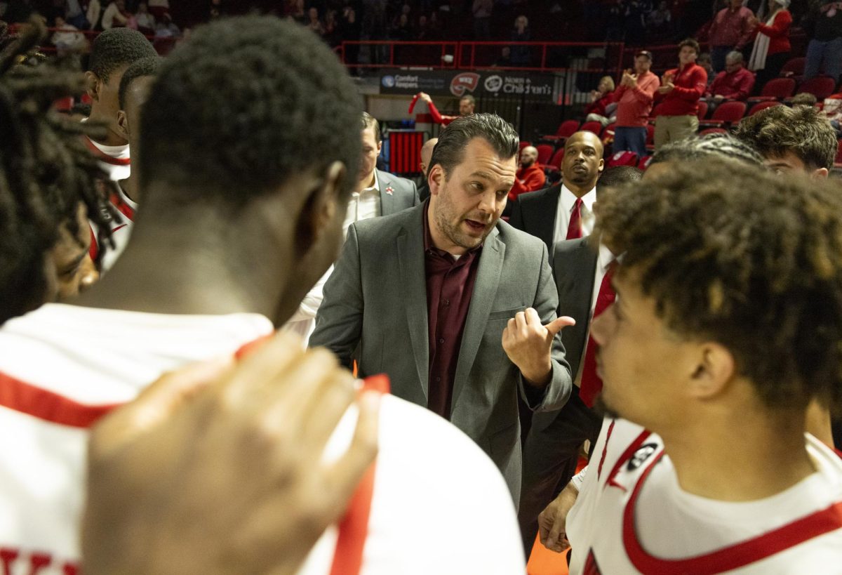 WKU head coach Hank Plona speaks with his team before  the Hilltopper's game against Tennessee State University in Bowling Green, Ky. on Tuesday, Dec. 10, 2024.