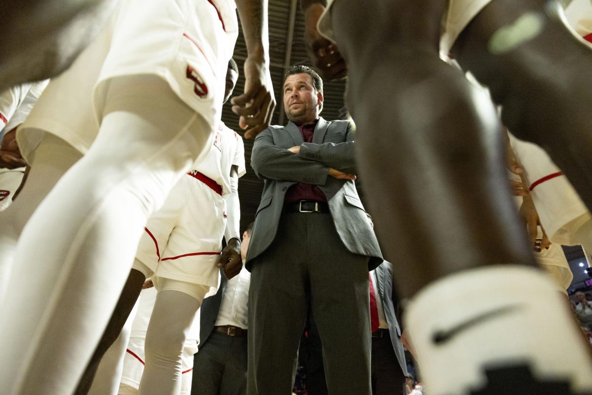 WKU head coach Hank Plona speaks with his team before the Hilltopper's game against Tennessee State University in Bowling Green, Ky. on Tuesday, Dec. 10, 2024.