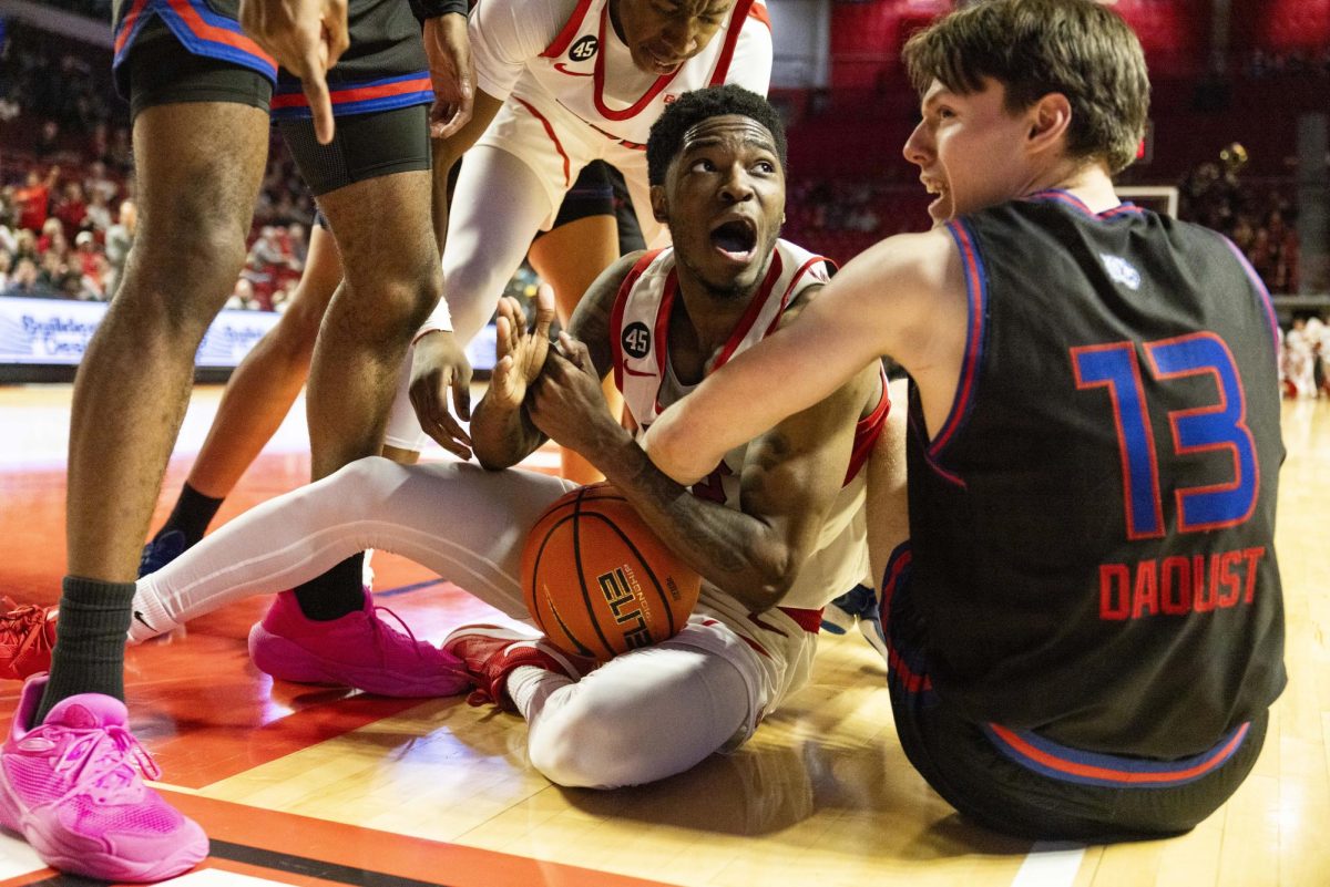 WKU guard Don McHenry (2) attempts to a call time out while wrestling for the ball during the Hilltopper's game against Tennessee State University in Bowling Green, Ky. on Tuesday, Dec. 10, 2024.