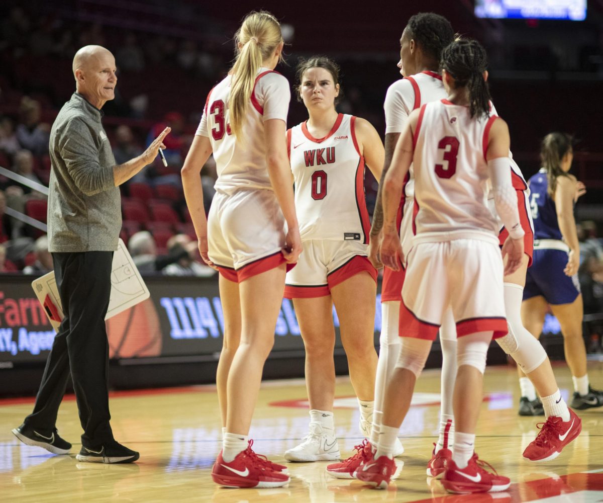 WKU head coach Greg Collins speaks with his team during the Lady Topper's game against the Kentucky Wesleyan Panthers in Bowling Green, Ky. on Wednesday, Dec. 11, 2024.