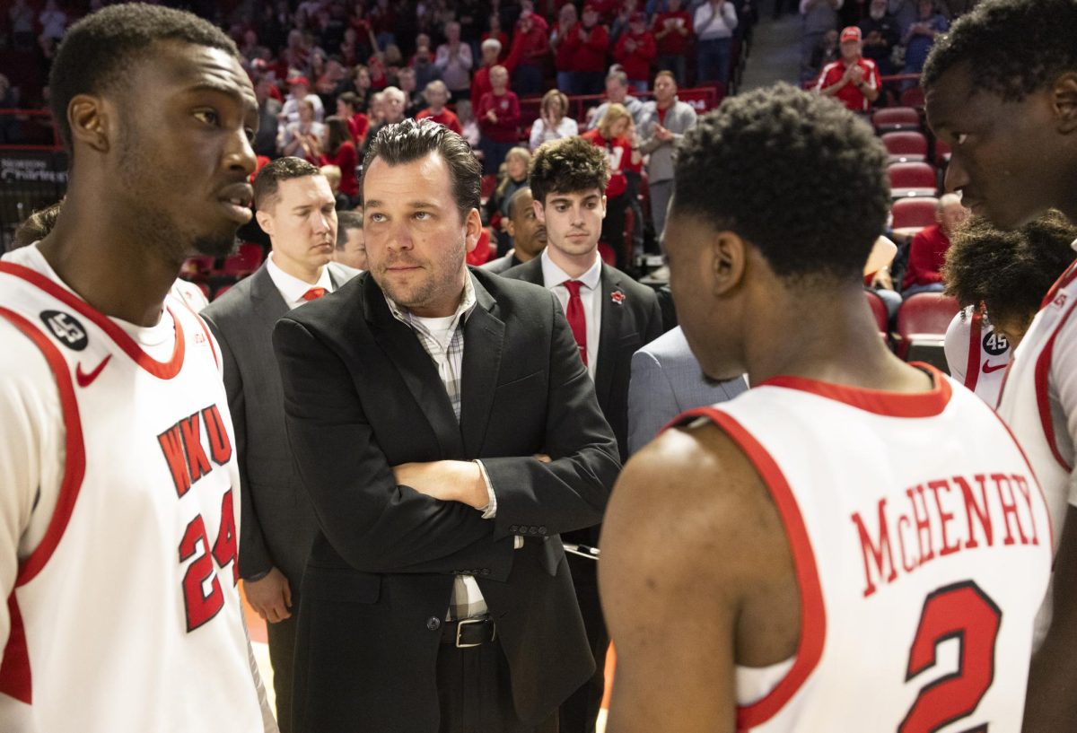 WKU head coach Hank Plona speaks with his team before the Hilltopper's game against the Murray State Racers in Bowling Green, Ky. on Saturday, Dec. 14, 2024.