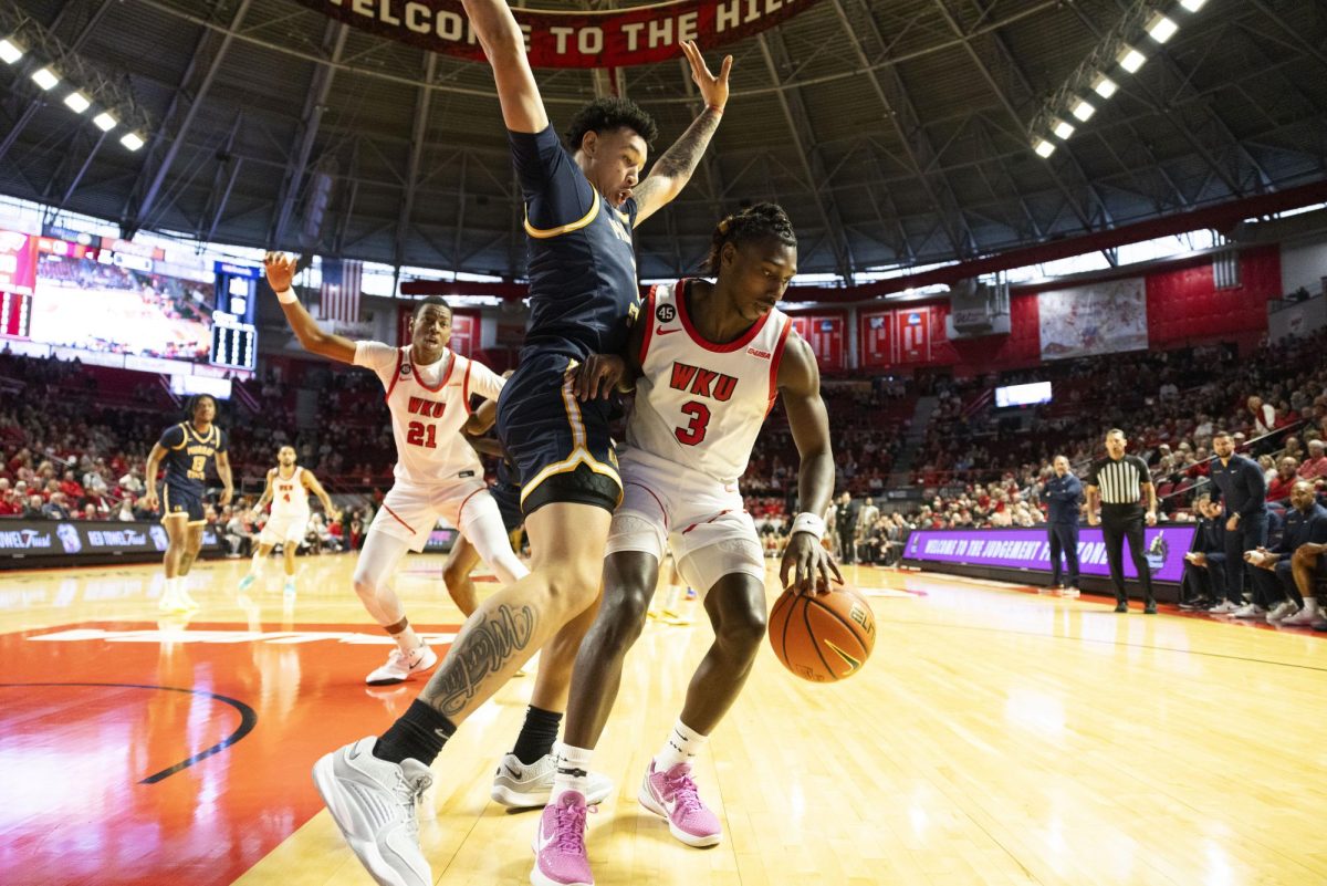 WKU guard Jalen Jackson (3) fights off defenders during the Hilltopper's game against the Murray State Racers in Bowling Green, Ky. on Saturday, Dec. 14, 2024.