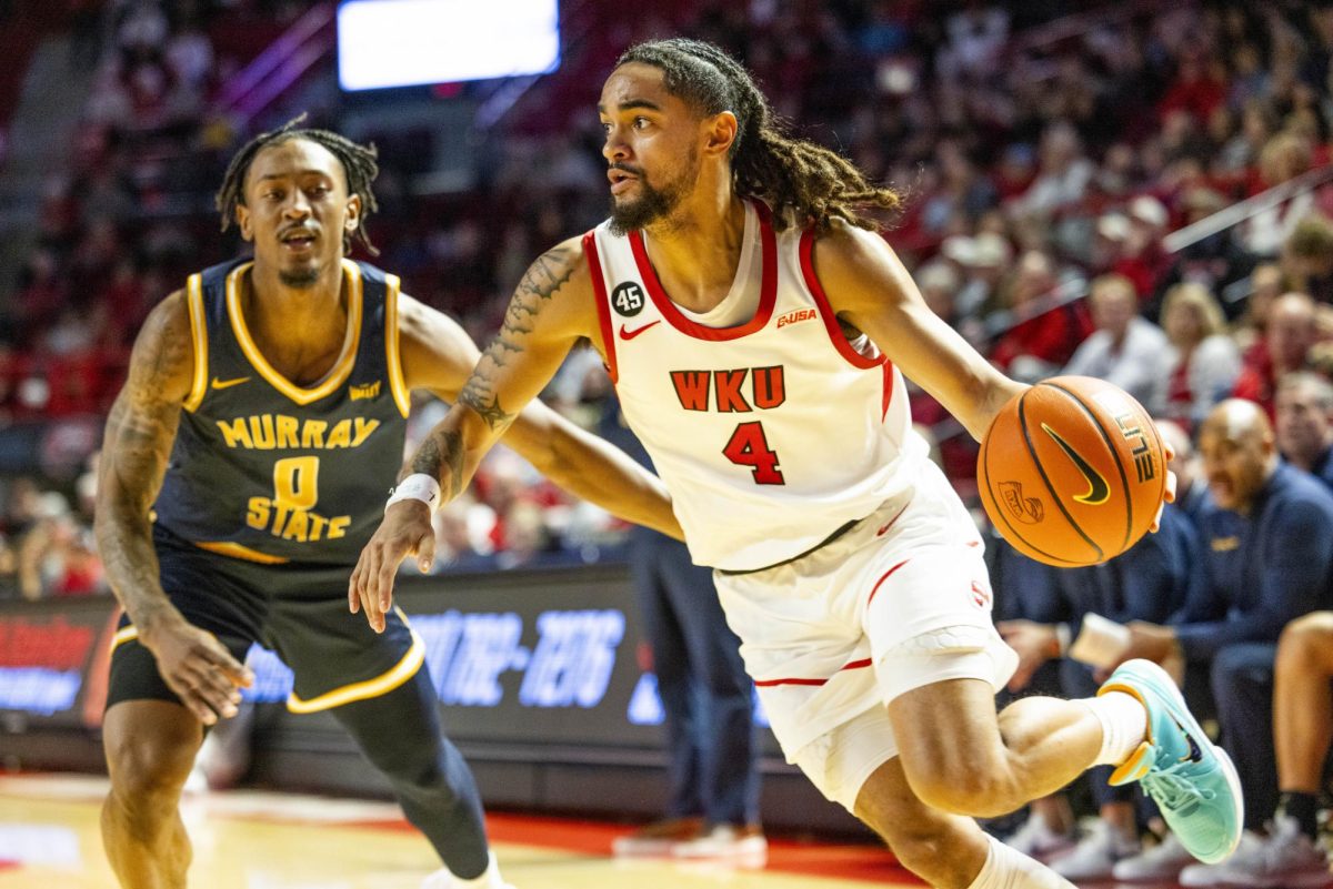 WKU guard Khristian Lander (4) drives the ball during the Hilltopper's game against the Murray State Racers in Bowling Green, Ky. on Saturday, Dec. 14, 2024.