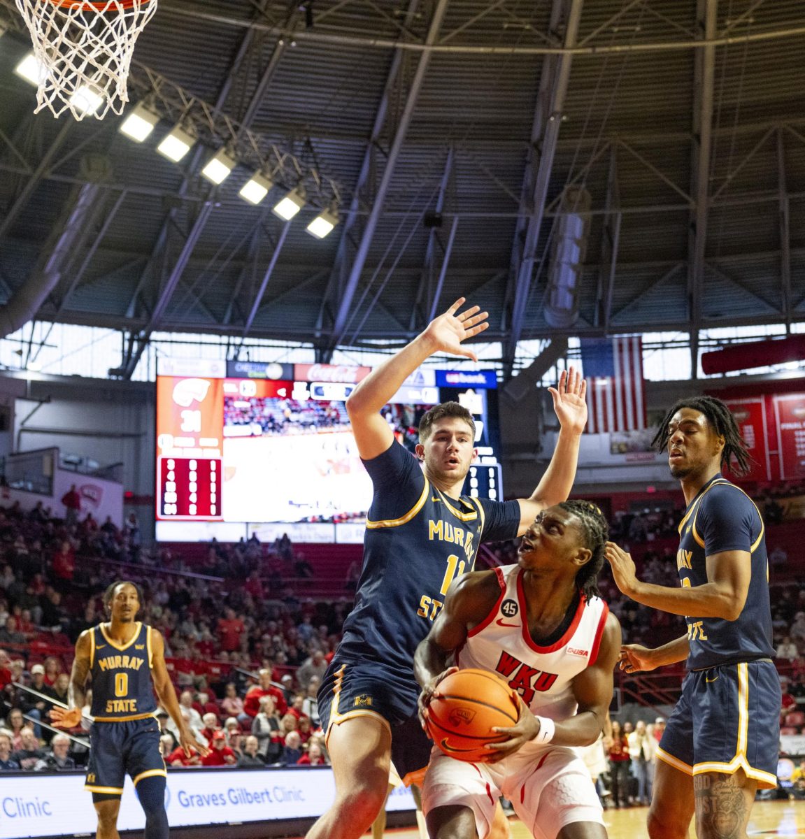 WKU guard Jalen Jackson (3) looks to the basket while being guarded during the Hilltopper's game against the Murray State Racers in Bowling Green, Ky. on Saturday, Dec. 14, 2024.