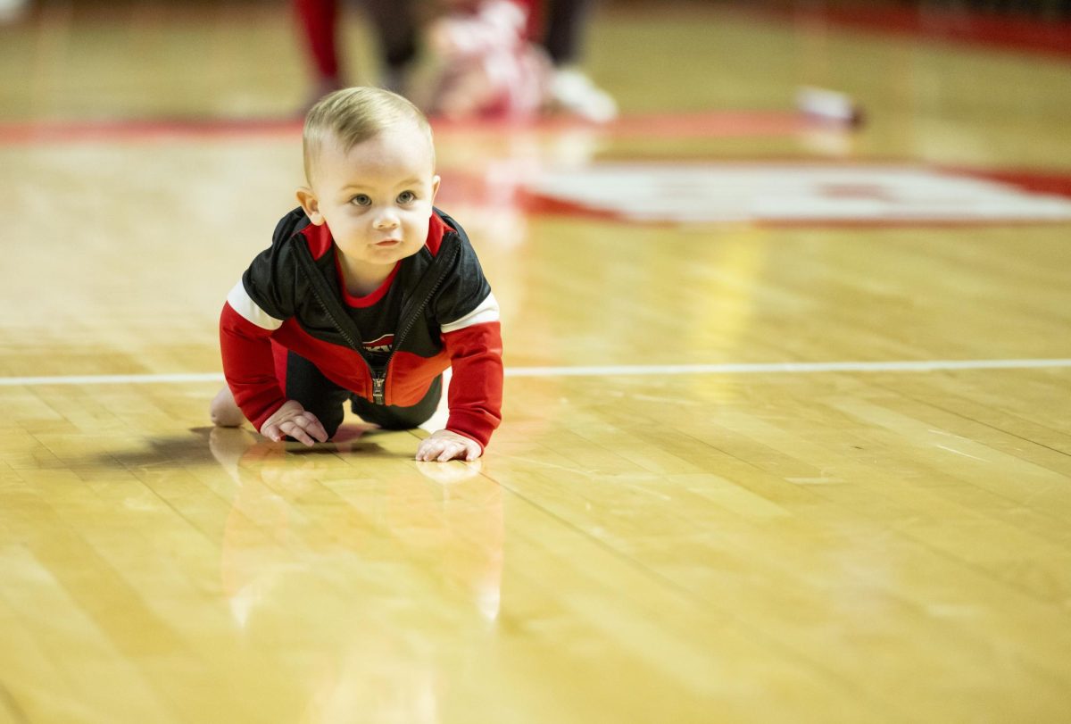 Knox Calvert, 1, particpates in the annual baby race during halftime at the Hilltopper's game against the Murray State Racers in Bowling Green, Ky. on Saturday, Dec. 14, 2024.