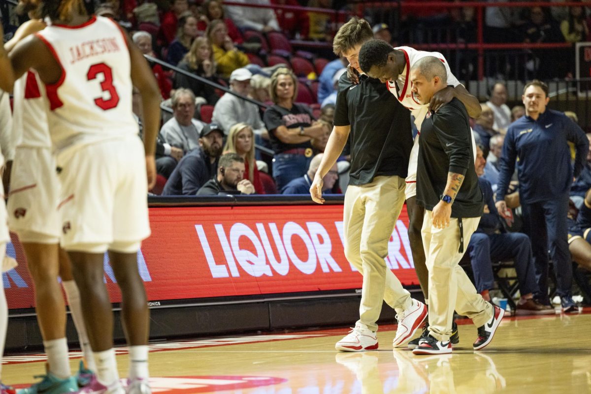 WKU forward Babacar Faye (5) is helped off the court after a hard fall during the Hilltopper's game against the Murray State Racers in Bowling Green, Ky. on Saturday, Dec. 14, 2024.