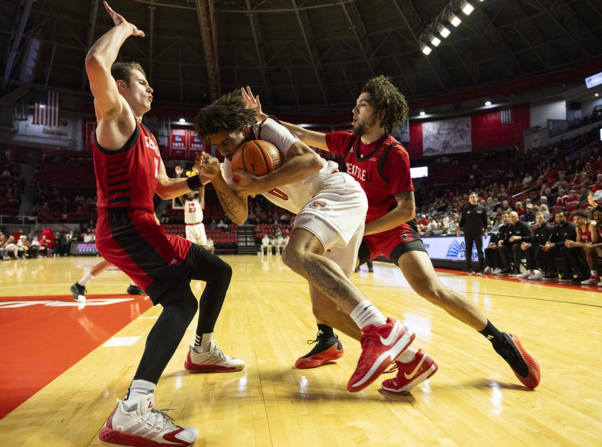 WKU guard Braxton Bayless (0) fights through defenders during the Hilltopper's game against the Seattle Redhawks in Bowling Green, Ky. on Tuesday, Dec. 17, 2024.