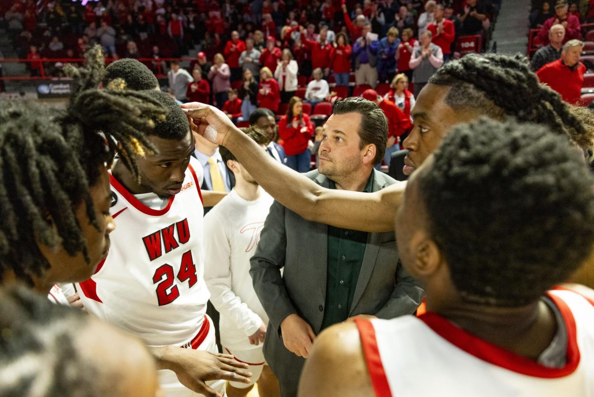 WKU guard Enoch Kalambay (23) picks at Tyrone Marshall Jr.'s hair before the Hilltopper's game against the Kentucky Wesleyan Panthers in Bowling Green, Ky. on Saturday, Dec. 21, 2024.