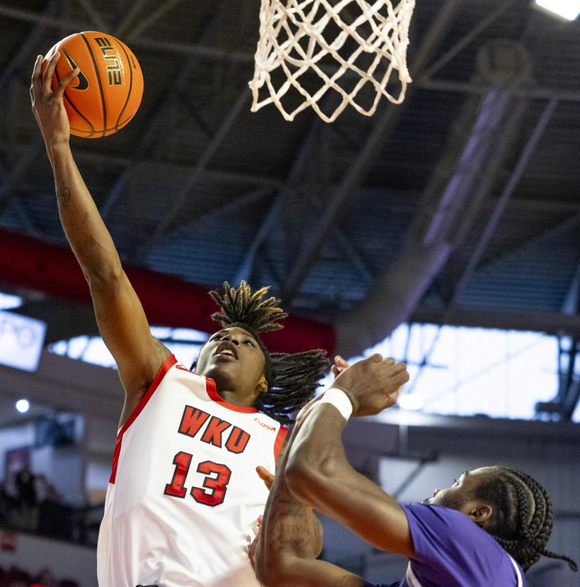 WKU guard Julius Thedford (13) makes a layup during the Hilltopper's game against the Kentucky Wesleyan Panthers in Bowling Green, Ky. on Saturday, Dec. 21, 2024.