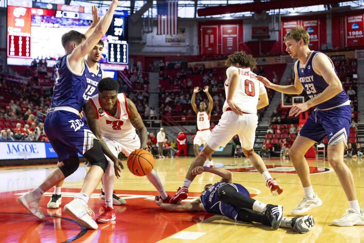 WKU guard Don McHenry (2) fights off defenders during the Hilltopper's game against the Kentucky Wesleyan Panthers in Bowling Green, Ky. on Saturday, Dec. 21, 2024.