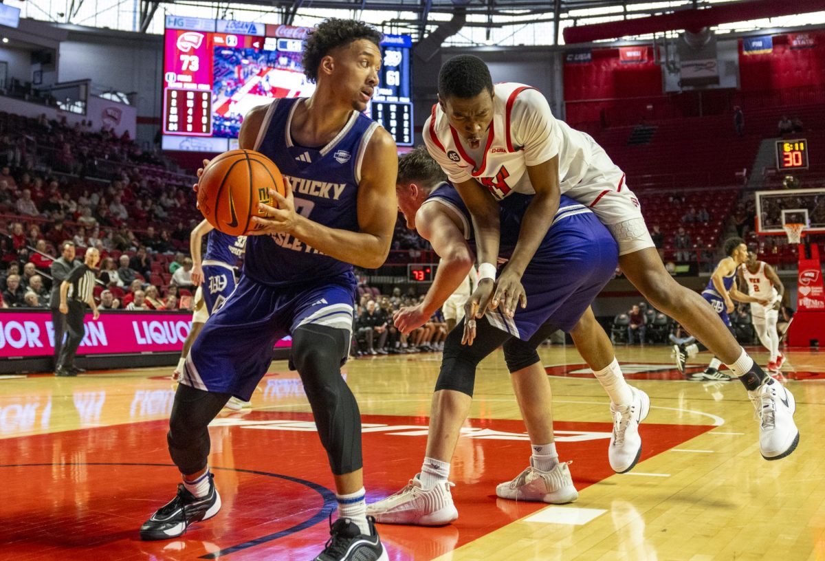 WKU forward Leeroy Odiahi (21) lands on another player during the Hilltopper's game against the Kentucky Wesleyan Panthers in Bowling Green, Ky. on Saturday, Dec. 21, 2024.