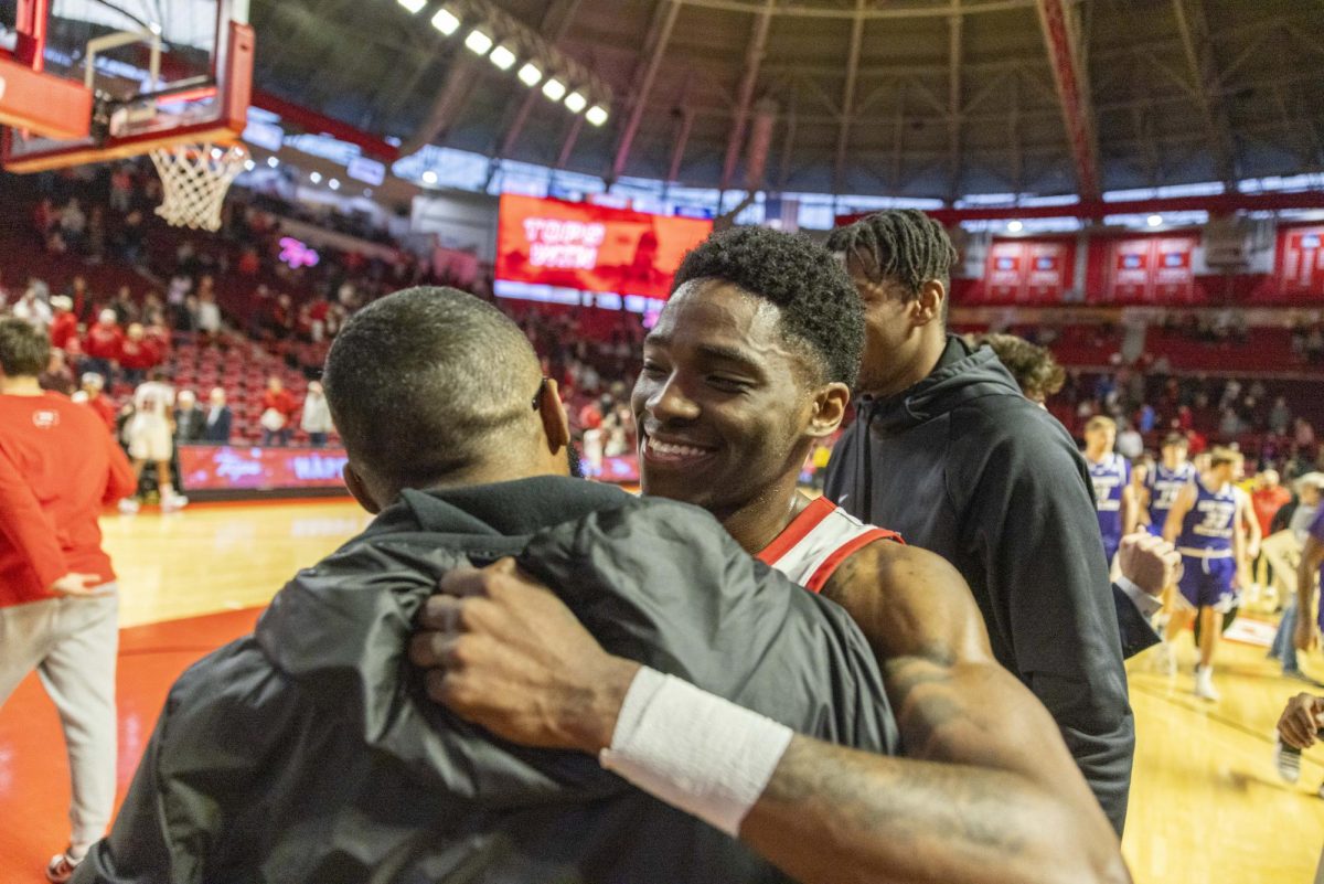 WKU guard Don McHenry (2) hugs Jay Justice after the Hilltopper's game against the Kentucky Wesleyan Panthers in Bowling Green, Ky. on Saturday, Dec. 21, 2024.