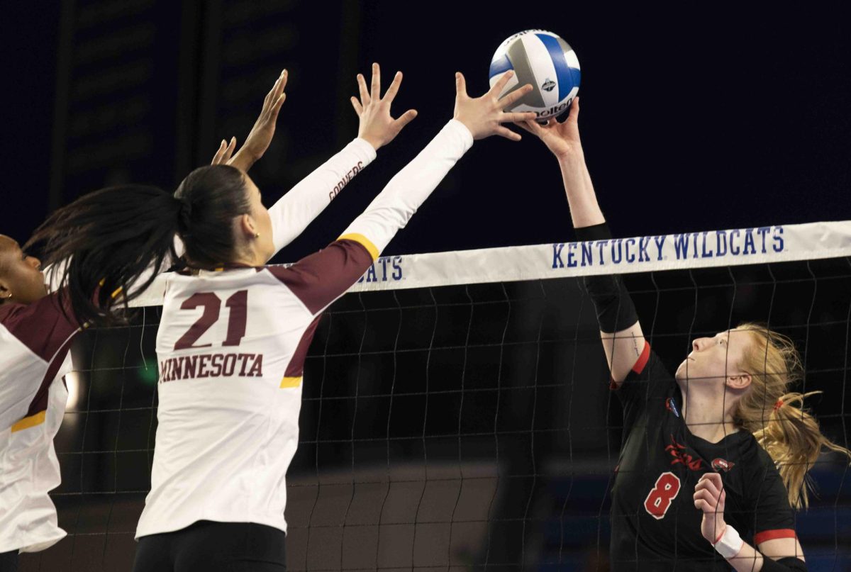 WKU outside hitter Kaylee Cox (8) taps the ball over the net during the volleyball game against the Minnesota Golden Gophers in the first round of the NCAA tournament held in the Memorial Coliseum in Lexington, Ky., on Thursday, Dec. 5, 2024.