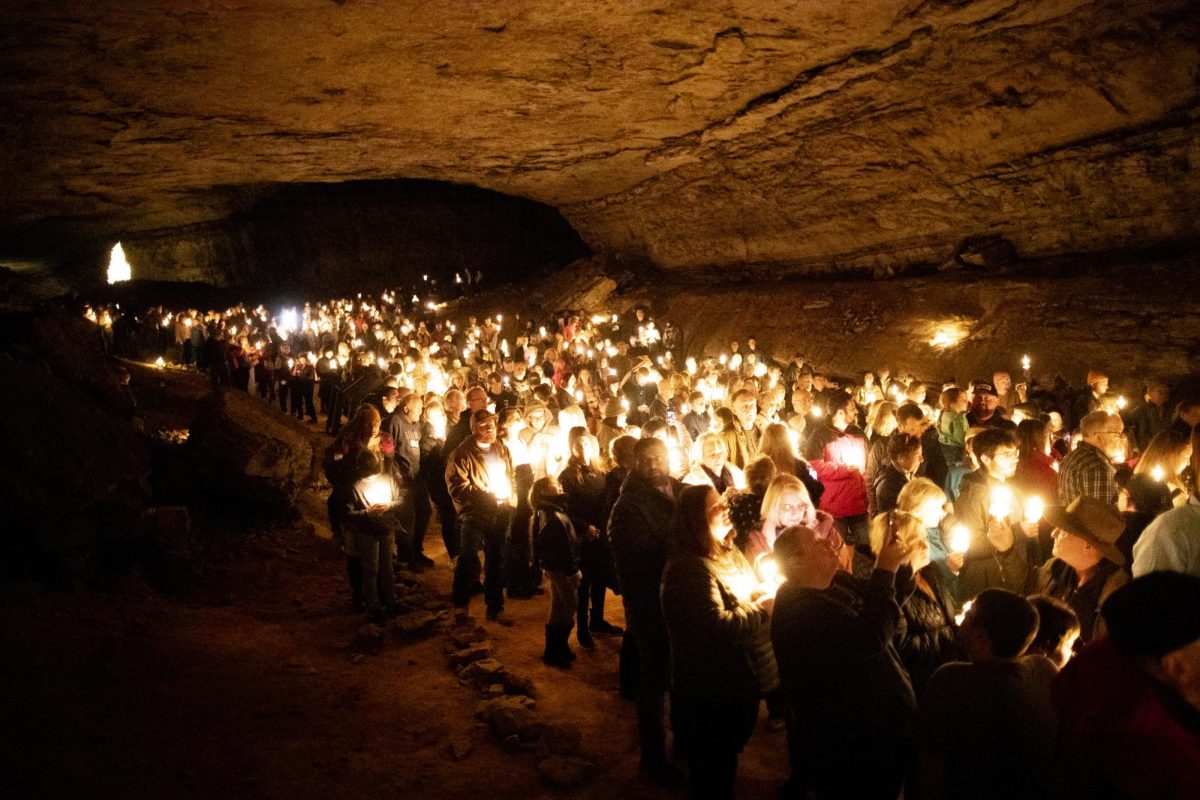 Cave visitors help each other light candles to illuminate Mammoth Cave’s vast and cold halls while singing “Silent Night” at the close of the 45th annual Cave Sing within the historic entrance of Mammoth Cave underneath Edmonson County, Ky. on Sunday, Dec. 1, 2024. 