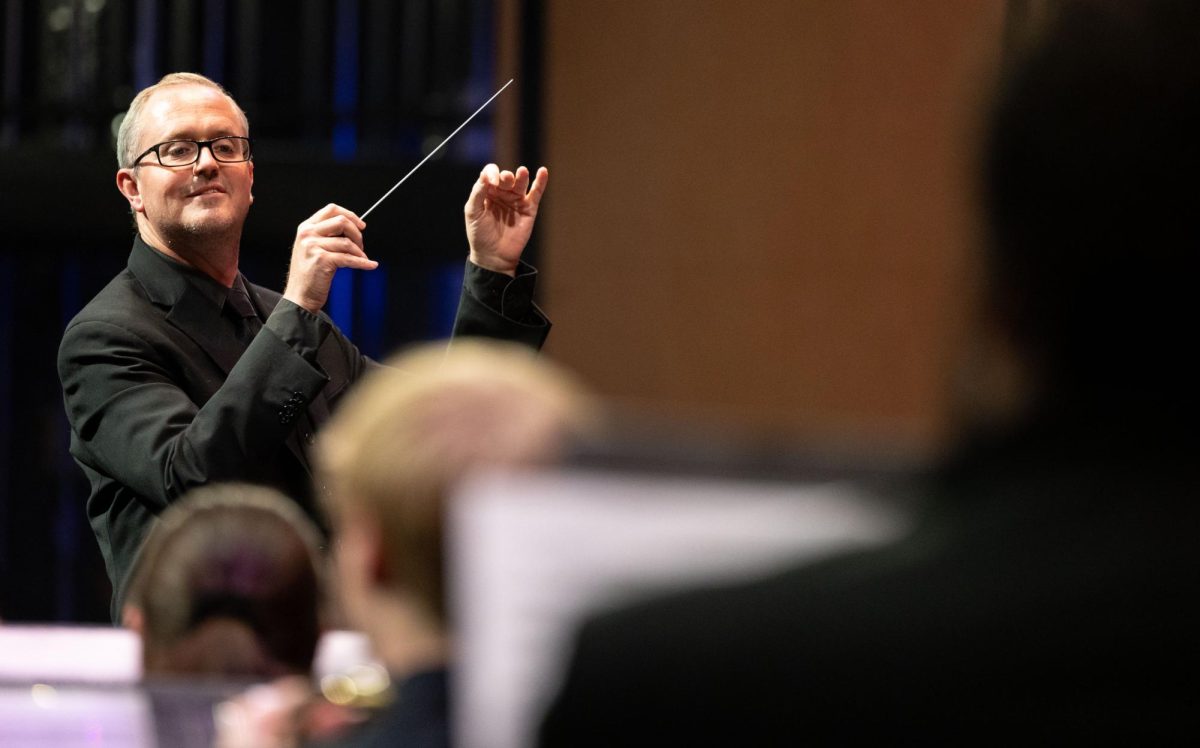 Associate Director of Bands Matthew McCurry conducts the wind ensemble in “Hounds of Spring” during the WKU Department of Music's annual PRISM Concert in Van Meter Hall on Friday, Jan. 24, 2025. 