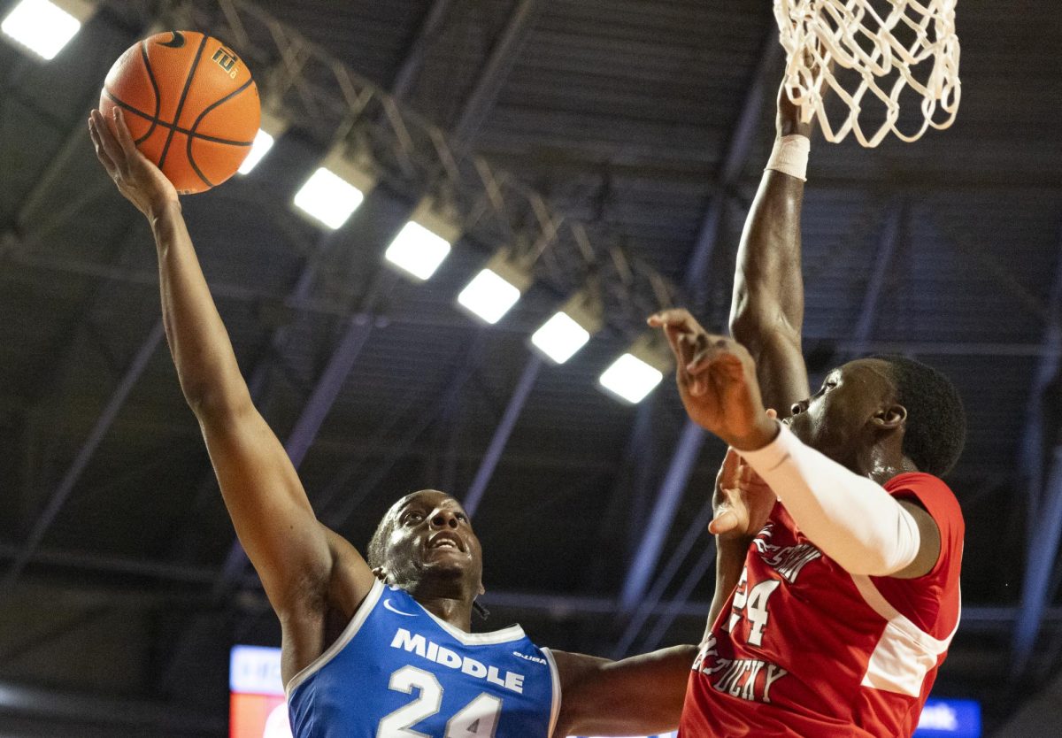 Blue Raider guard Camryn Weston (24) attempts a layup while being guarded by Western Kentucky Hilltoppers forward Tyrone Marshall Jr. (24) during the Hilltoppers game against the Middle Tennessee State University Blue Raiders in Bowling Green, Ky. on Saturday, Feb. 15, 2025. 