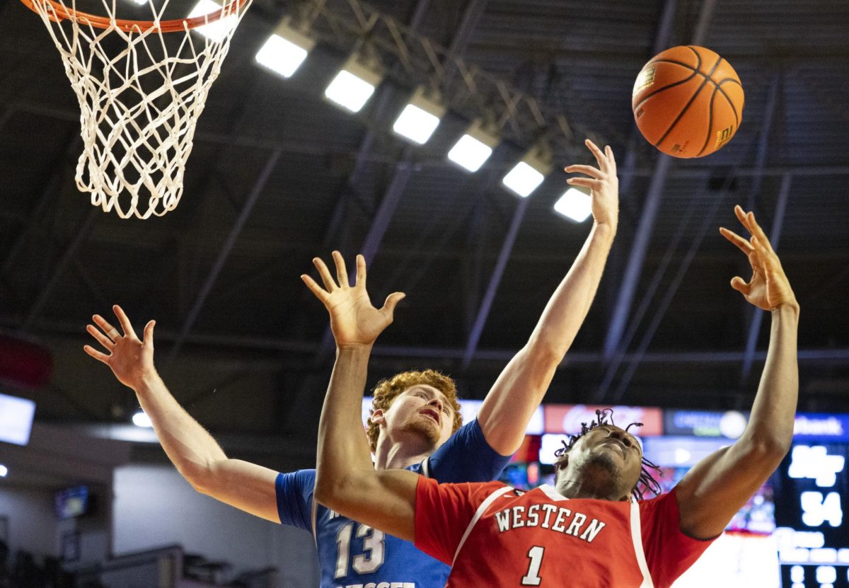 Western Kentucky Hilltoppers forward Blaise Keita (1) and Blue Raider forward Chris Loofe (13) attempt to rebound the ball during the Hilltoppers game against the Middle Tennessee State University Blue Raiders in Bowling Green, Ky. on Saturday, Feb. 15, 2025. 