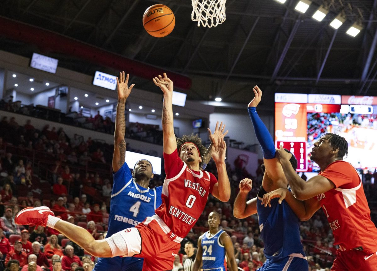 Western Kentucky Hilltoppers guard Braxton Bayless (0) takes a shot while falling into defenders during the Hilltoppers game against the Middle Tennessee State University Blue Raiders in Bowling Green, Ky. on Saturday, Feb. 15, 2025. 