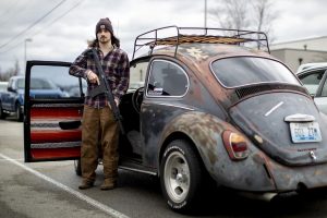 Colin Walters of Bonnieville, Ky. showcases his 1968 Volkswagen air-cooled Beetle and his 12-gauge AR-style shotgun which he had tried to sell at “Steve’s Gun and Knife Show” in Cave City, Ky. on Saturday, Feb. 8, 2025. 