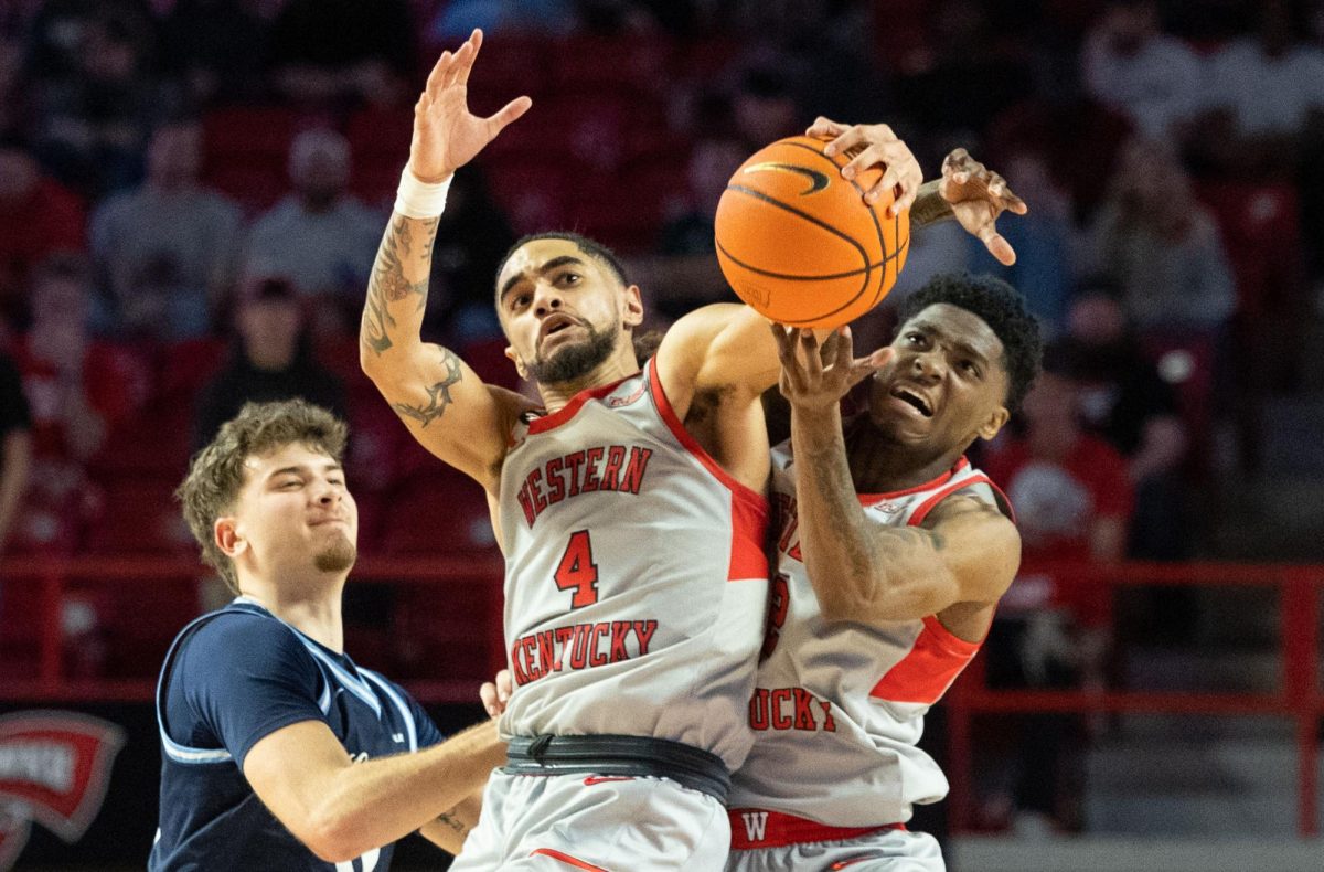 Western Kentucky Hilltoppers guard Khristian Lander (4), left, and Western Kentucky Hilltoppers guard Don McHenry (2) go for a loose ball during a game against Liberty University at Diddle Arena on Saturday, March. 8, 2025.