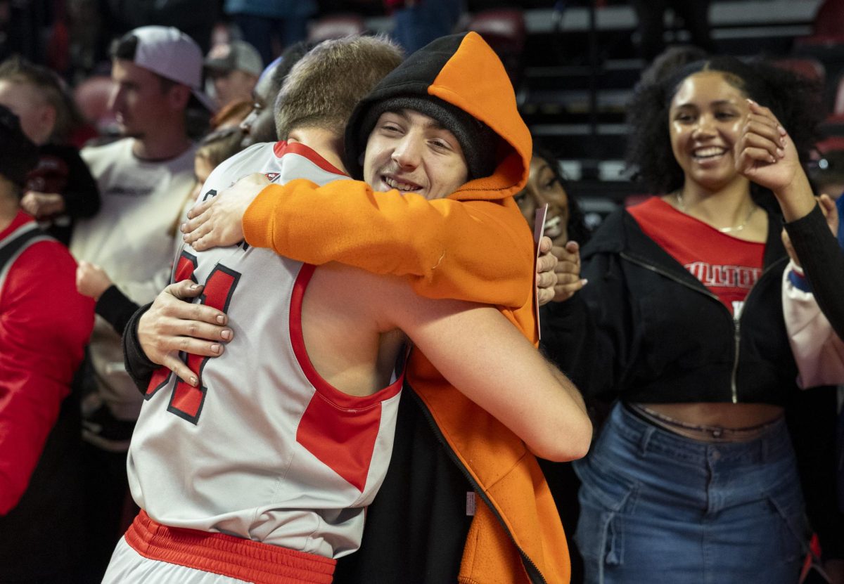 Fan Thomas White hugs Western Kentucky Hilltoppers guard Tyler Olden (31) after a game against Liberty University at Diddle Arena on Saturday, March. 8, 2025.