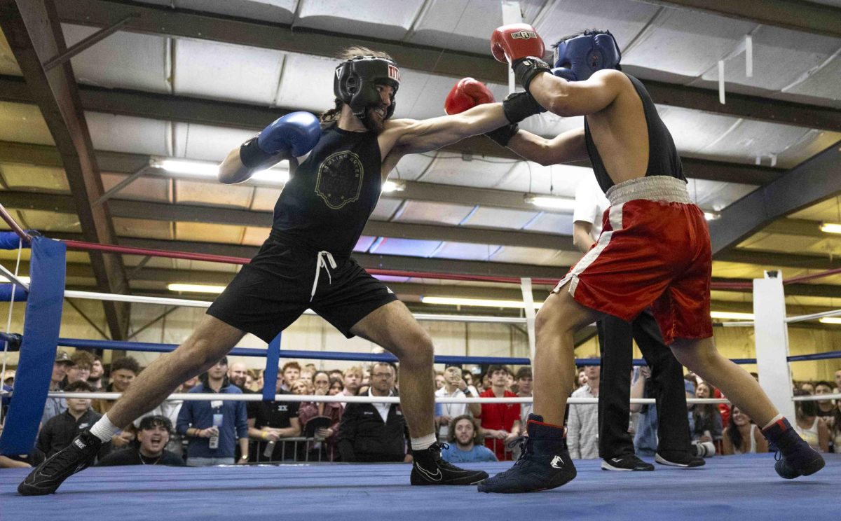 Noah Lanford jabs at Sigma Chi boxer Dat Nguyen during the fourth fight of  of the Sigma Chi Fight Night event in Bowling Green, Ky., on Friday, Feb. 28, 2025. 
