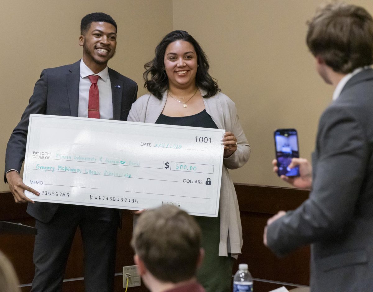 Kyana Edmonds receives the Gregory McKinney Leadership and Involvement Black History Month Scholarship from Student Body Vice President Donte Reed during the Student Government Association’s meeting on Tuesday, Mar. 25, 2025.