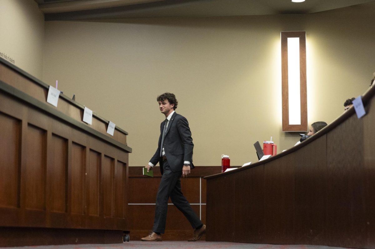 SGA President Rush Robinson walks to the podium to begin his report during the SGA meeting on Tuesday, Aug. 26, 2025, in the Senate Chambers of the Downing Student Union building at Western Kentucky University.