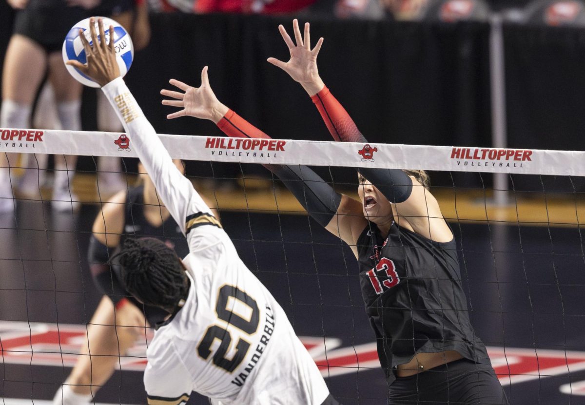Western Kentucky University outside hitter Kendall Meller (13) attempts to block the ball against Vanderbilt middle hitter Jackie Moore (20) on September 16, 2025 during the game against Vanderbilt in E.A. Diddle Arena. 