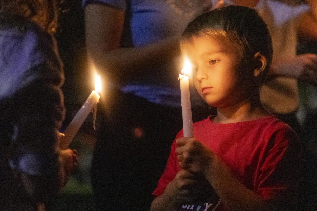 Austin Rogers holds a candle during the WKU chapter of Turning Point USA’s vigil for conservative commentator Charlie Kirk on the South Lawn on Thursday, Sept. 25, 2025.