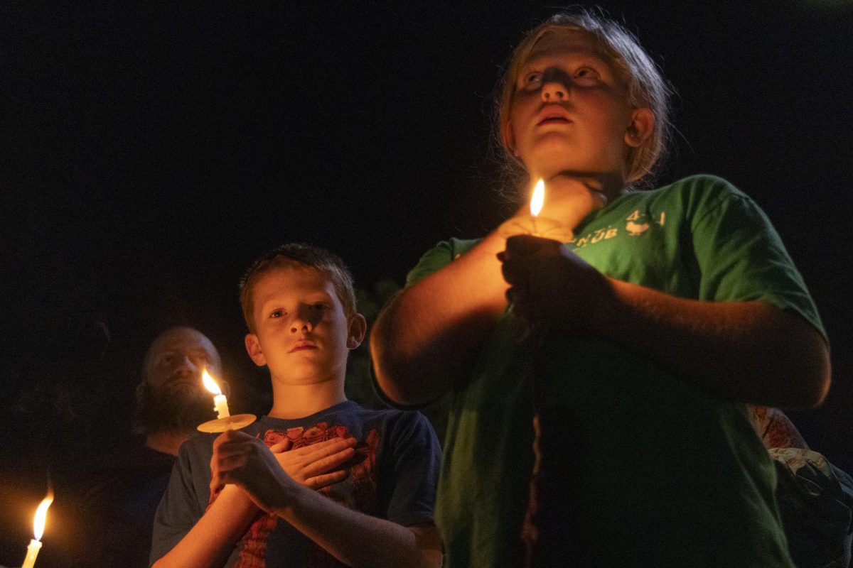 Bear and Tabitha Sweets hold their hand over their heart as the national anthem is played during the WKU chapter of Turning Point USA’s vigil for conservative commentator Charlie Kirk on the South Lawn on Thursday, Sept. 25, 2025.