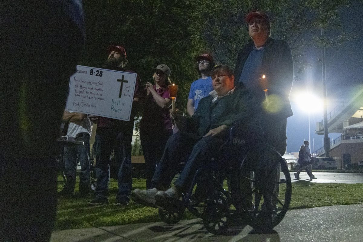 Mike and Laura Fevold listen and hold candles during the WKU chapter of Turning Point USA’s vigil for conservative commentator Charlie Kirk on the South Lawn on Thursday, Sept. 25, 2025.