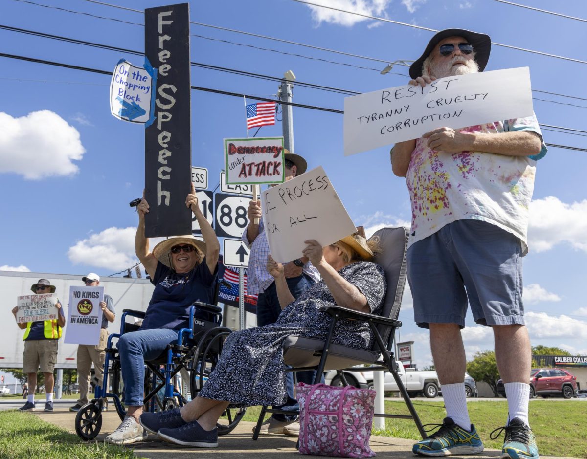 Protesters display signs showing unrest with the American political climate during the SOKY Indivisible Four Corner protest on Saturday, Sept. 27, 2025.
