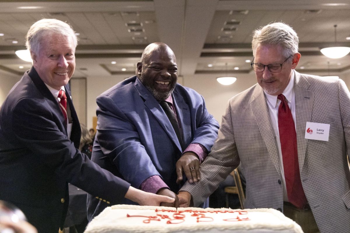 (FILE PHOTO) WKU Professor and University Historian David Lee, left, WKU Dean of PCAL Terrance Brown, center, and WKU professor emeritus and retired PCAL Dean Larry Snyder, right, cut a celebratory cake on Friday, Sept. 19, 2025 for PCAL’s 60th Anniversary Soirée in Knicely Conference Center. 