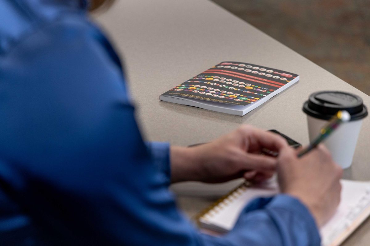 Mariah Yates’ book sits on the table as Kelly Wright listens to Yates during her presentation at the WKU Innovation Campus on Sept. 11, 2025.